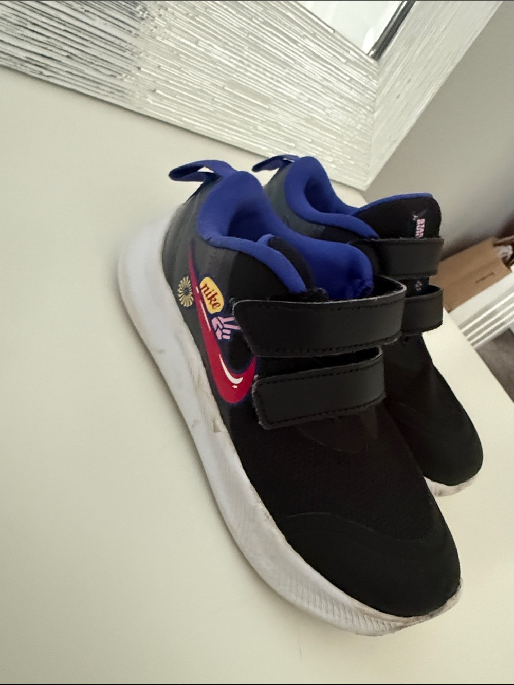Nike Kids Black Sneakers with Blue Lining and Red Swoosh